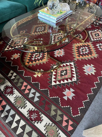 8 by 5 foot large red Turkish kilim area rug featuring large diamond medallions in the center and multiple striped borders around the outside