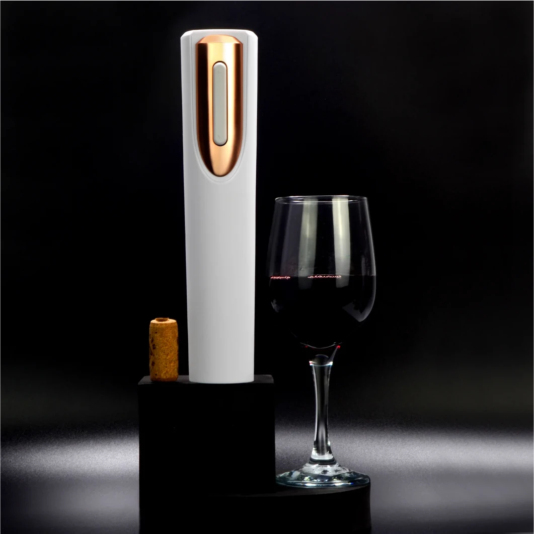 An elegant electric wine opener beside a glass of red wine and a cork on a dark background.