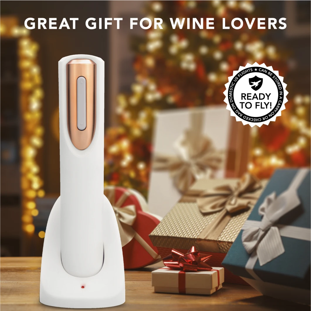 An electric wine opener in front of blurred Christmas gifts with a festive background.