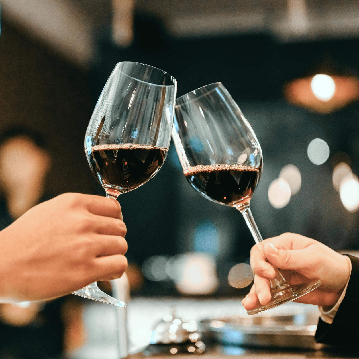 Cheersing glasses of red wine | Macy's Wine Shop