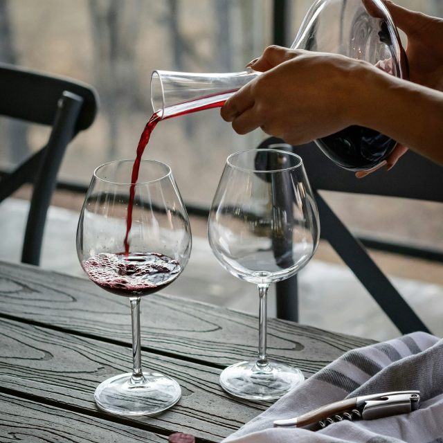 Pouring red wine into a decanter