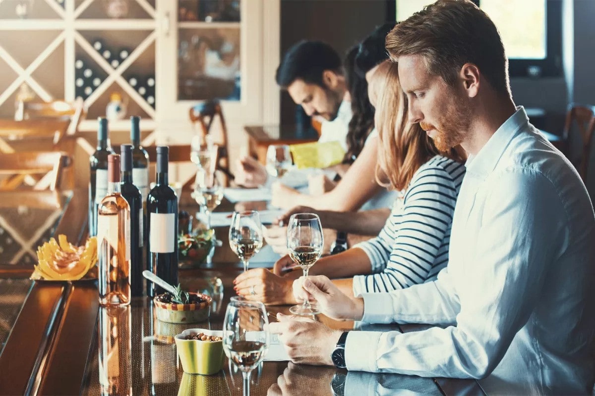 A man studying wine