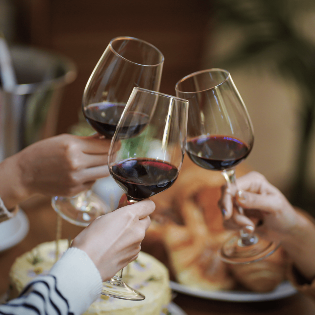 Cheersing glasses of red wine | Macy's Wine Shop