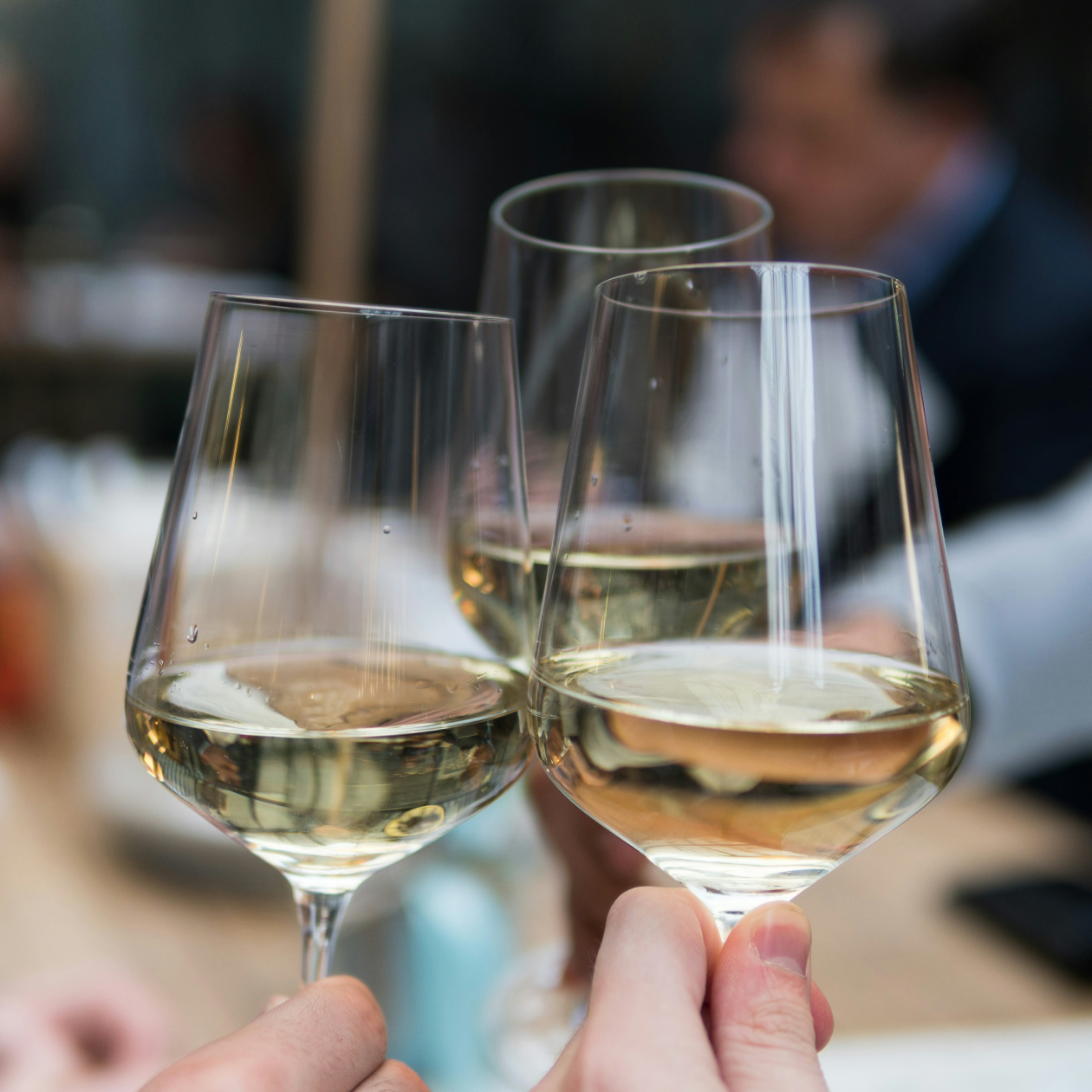 Cheersing glasses of white wine