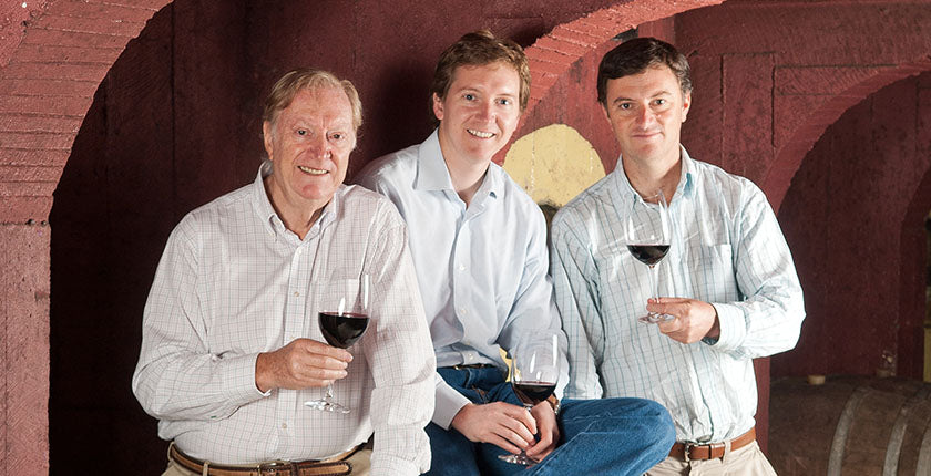 Three men with glasses of red wine