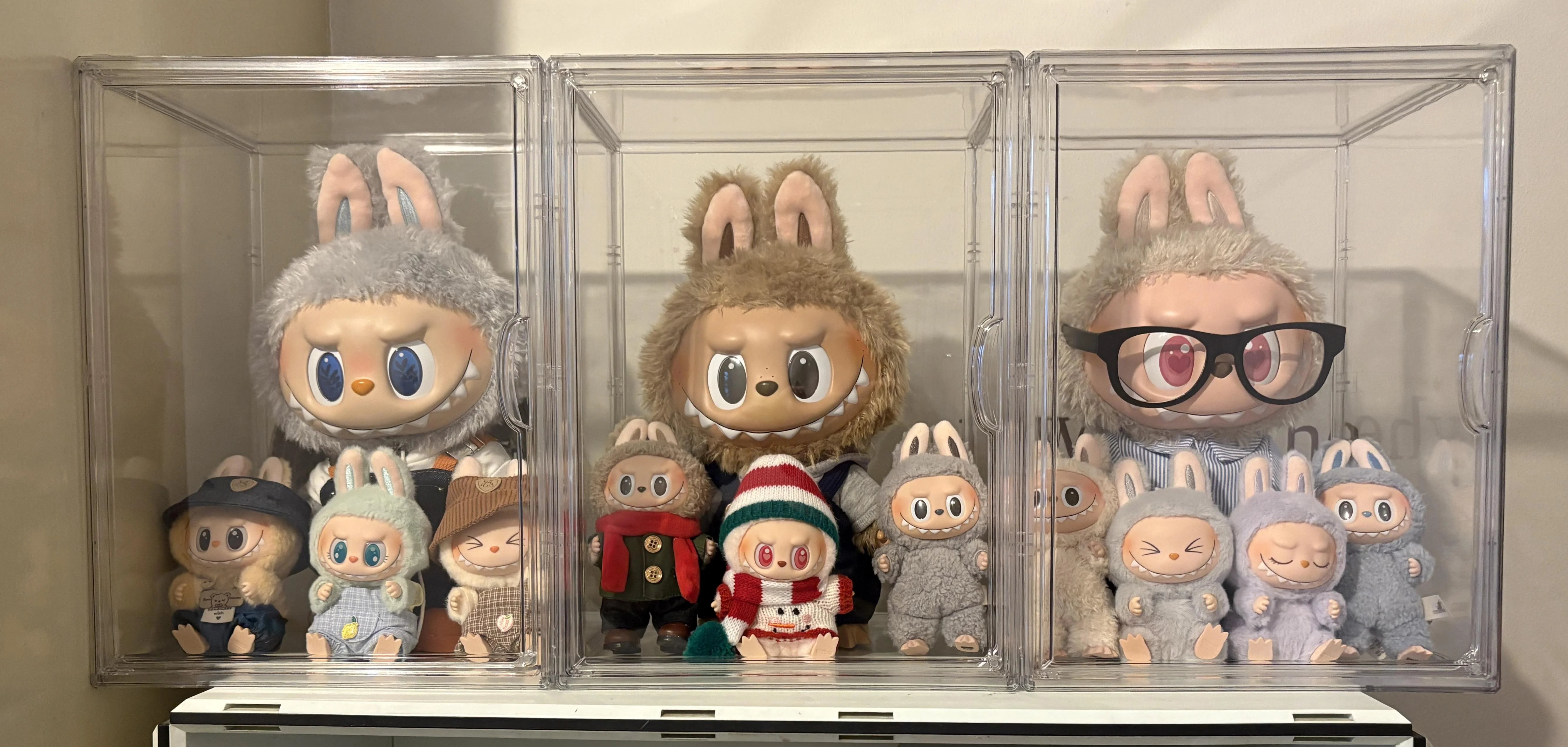 Labubu figures displayed in transparent storage boxes