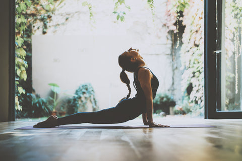 Portrait of gorgeous young woman practicing yoga indoors