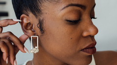 Confident woman wearing a pair of statement earrings 