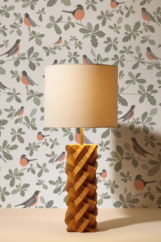 Robins wallpaper designed by Kate Golding with a close-up of a vintage table lamp.