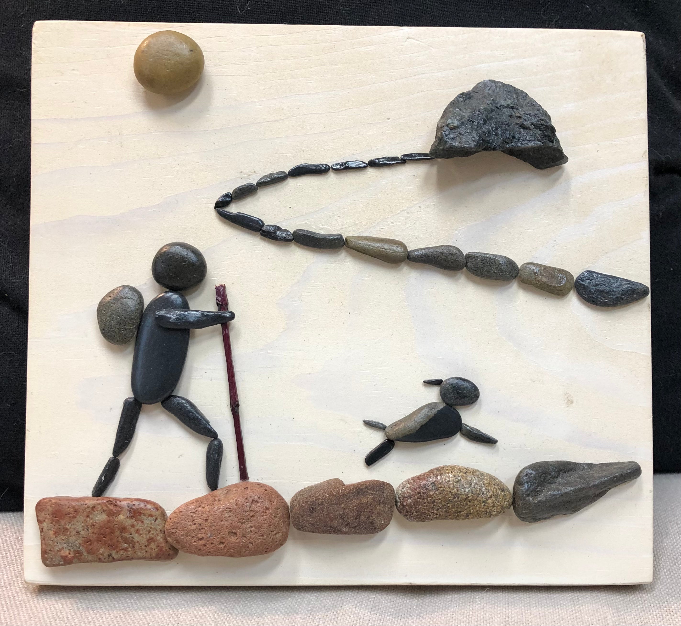 Wildwoods creation WA beach and rock art hiking person with a dog pebble art.  WA Beach & River Pebble Art, Made in Snoqualmie, WA