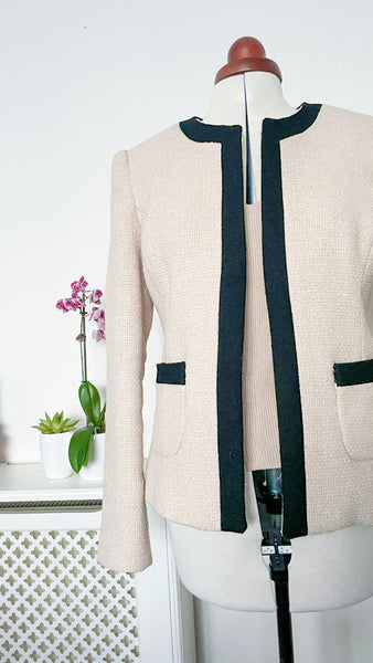 Image shows a tweed jacket on a mannequin