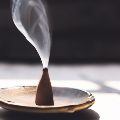 incense cone burning in holder with smoke