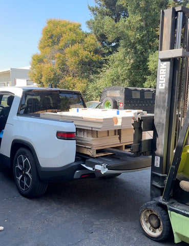 forklift sliding parts into the back of the Rivian