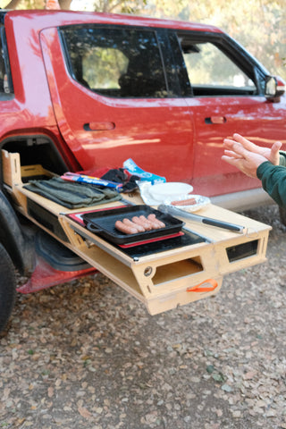 Rivian R1T with Thunderbolt Camp Kitchen cooking sausages