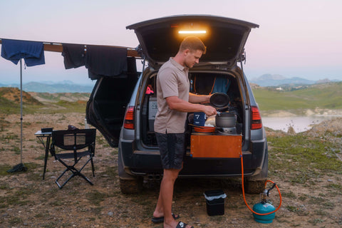 Niko cooking at the back of his vehicle