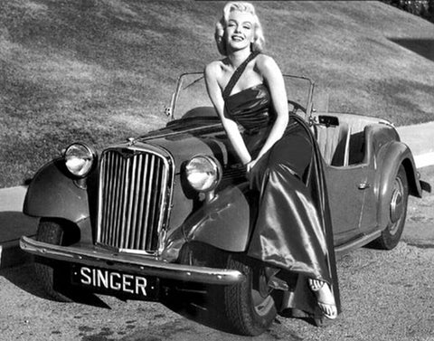 Marilyn Monroe in a gown by a car