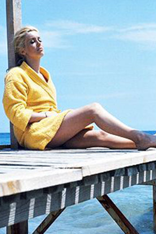 Catherine Deneuve in a yellow robe