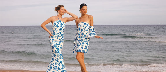 Girls on the beach in blue and white dresses