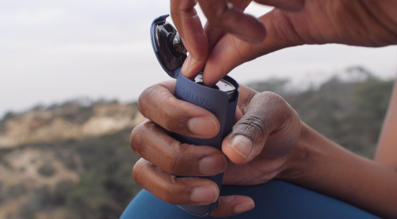 MIQRO vaporizer being loaded with flower