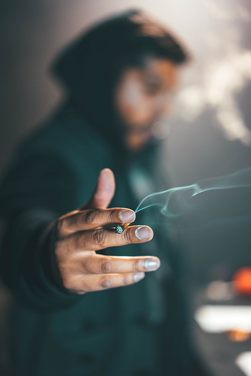 Young man smoking cannabis