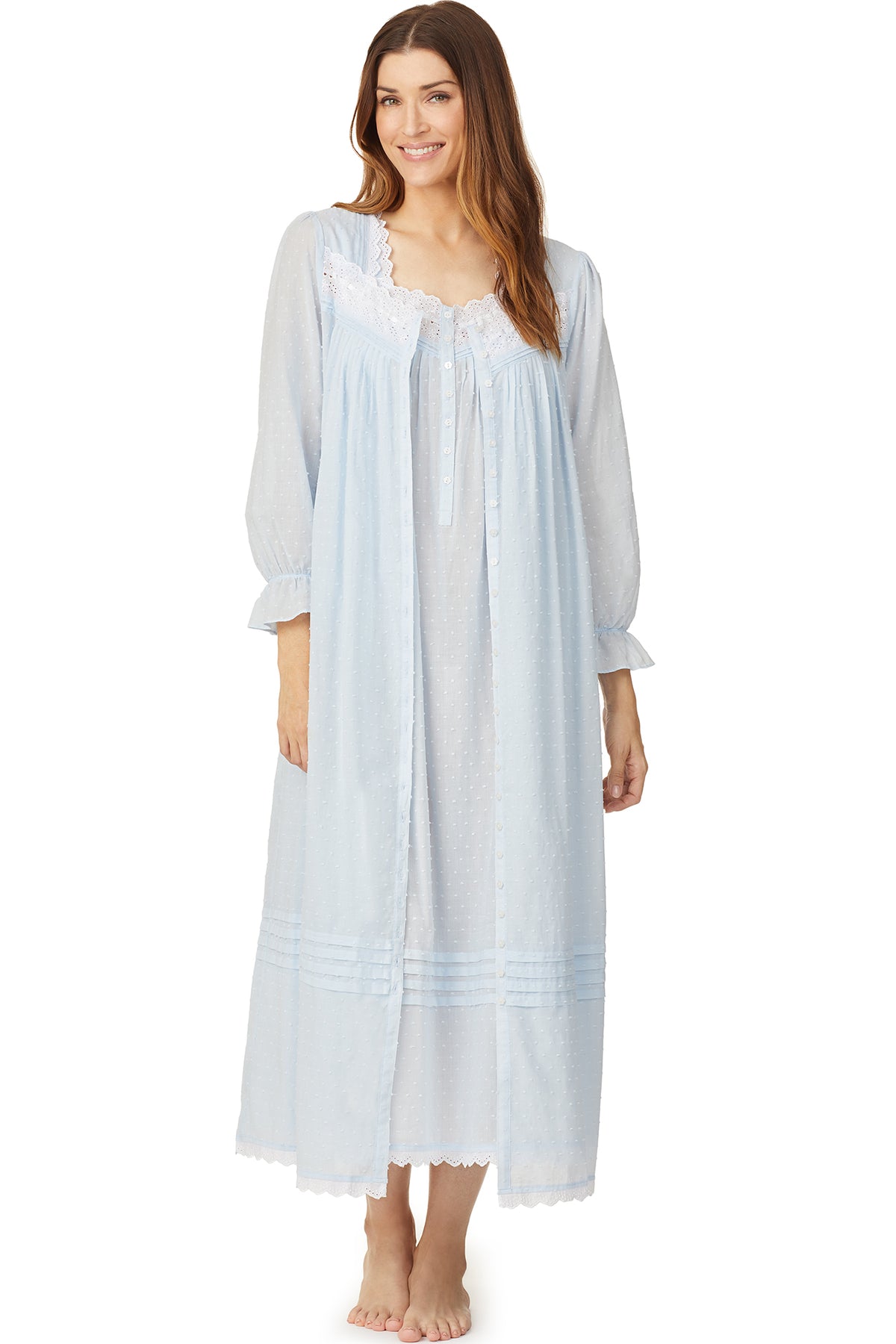 A lady wearing a blue long sleeve button front robe with white dot pattern.
