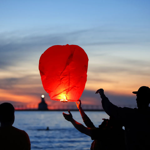 Family lunching a rice paper flying lantern