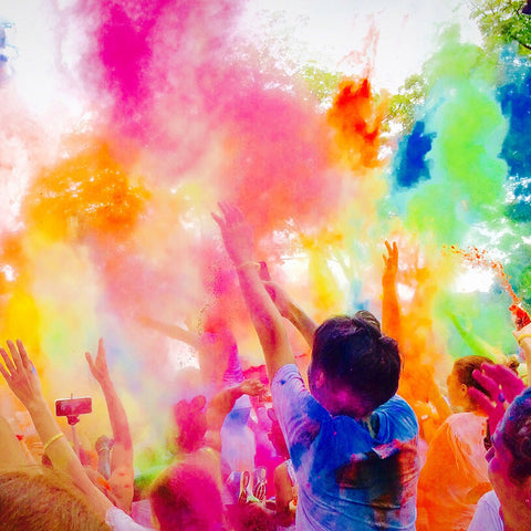 People throwing Colour Powder at each other in a Canadian event