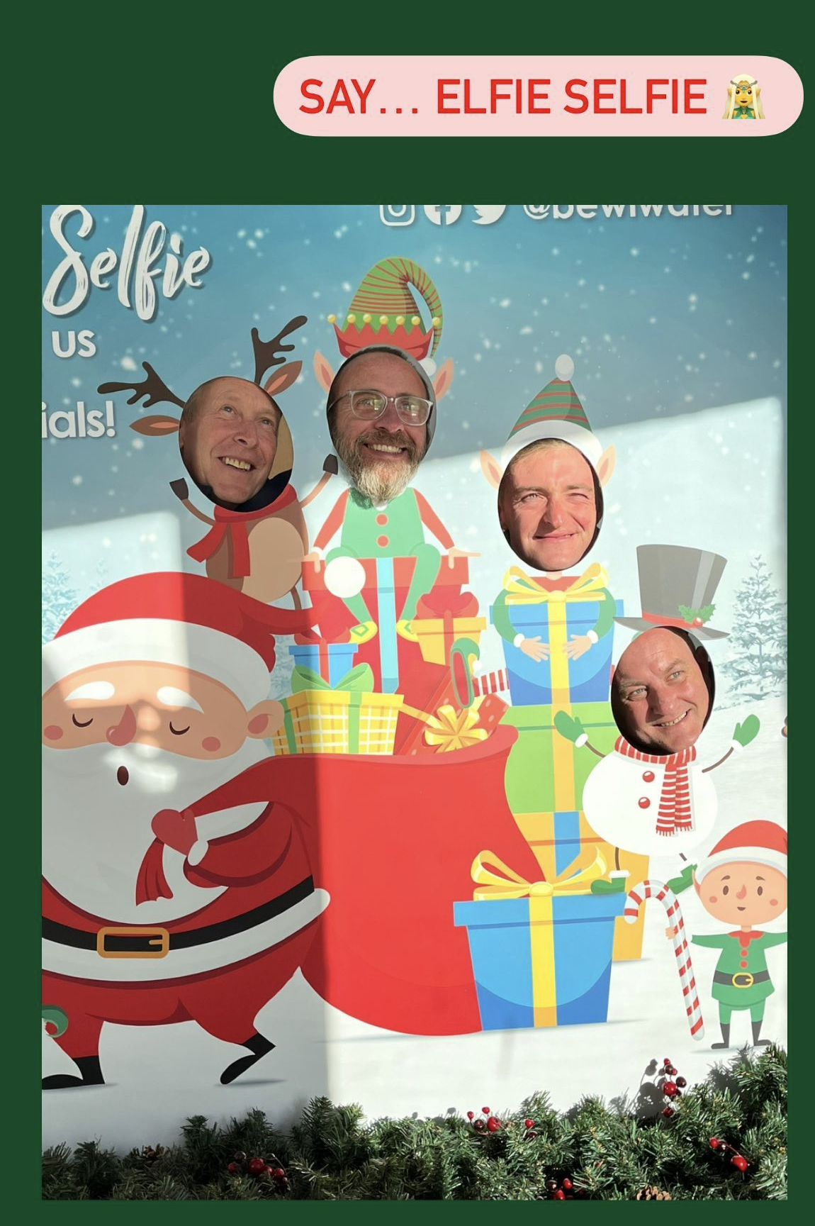 staff at Bewl Water putting their faces in the cutout holes for christmas photo