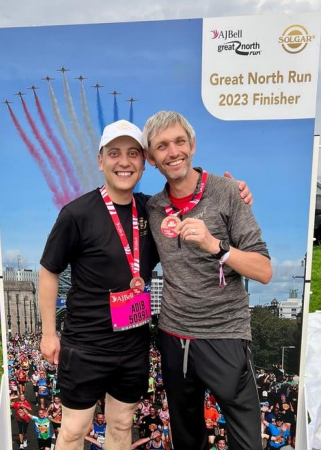 great north run participants celebrating in front of photo board