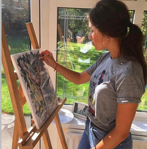 Lincolnshire artist, Eve Leoni Smith, painting a ballerina on canvas using acrylic paints.