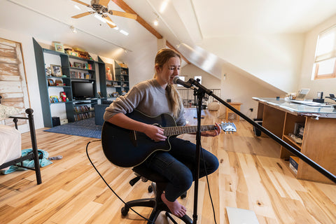 fourteen year old teenage girl playing her guitar