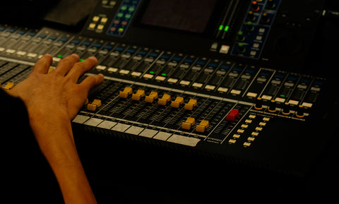 hand of sound engineer on the control panel