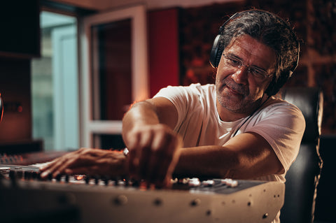 senior hispanic music producer working on a mixing studio