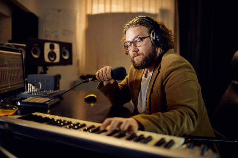 sound engineer holds microphone recording studio