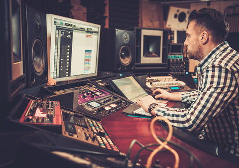 sound engineer working at mixing panel