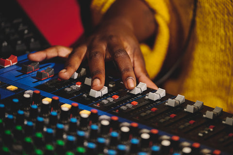 unrecognizable sound engineer working on mixing console blog feature