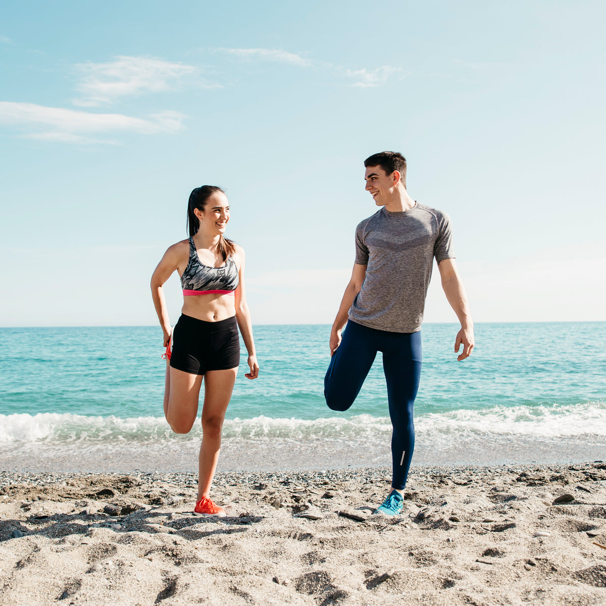 couple-stretching-beach.jpg__PID:13f19767-d02a-4b60-8d47-e0aa8461bb3f