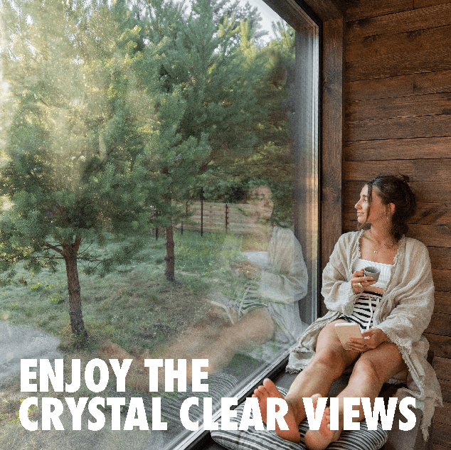 woman_enjoying_the_crystal_clear_views_large_window_nature