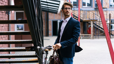 Man in suit arriving at work with their bicycle