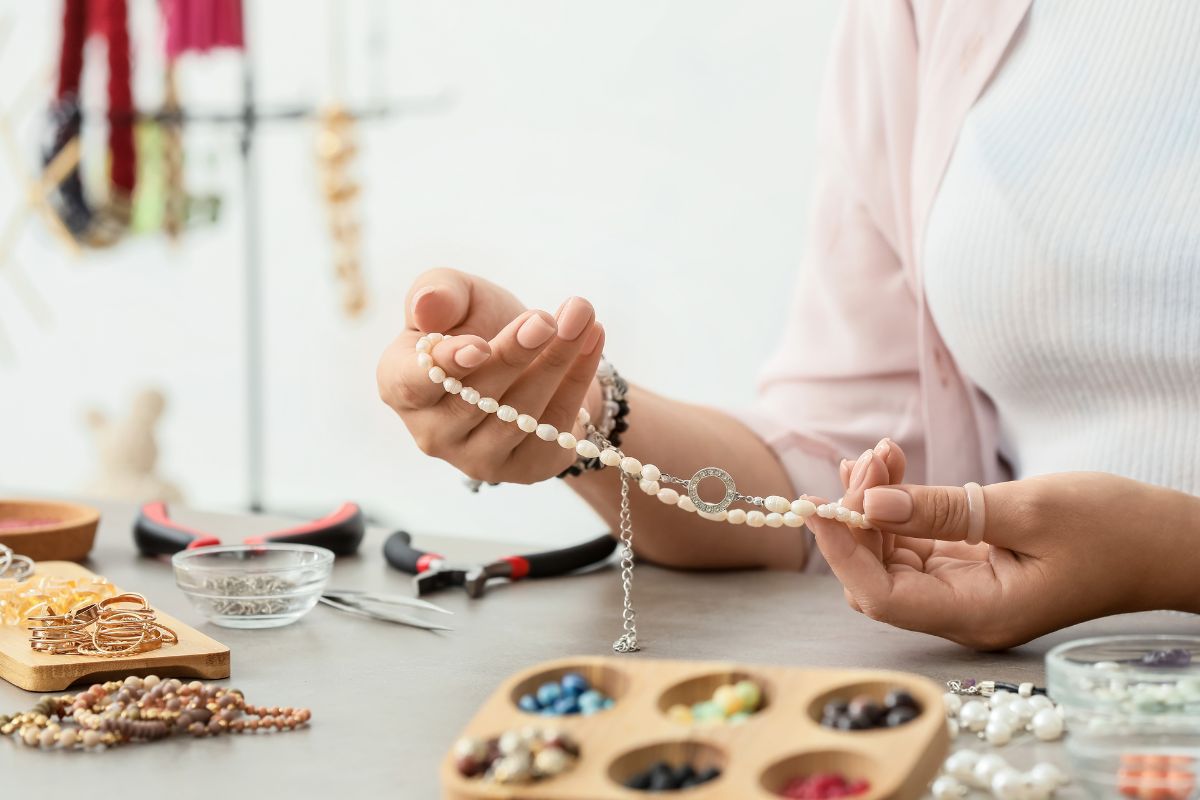 A lady inspecting costume jewelry.