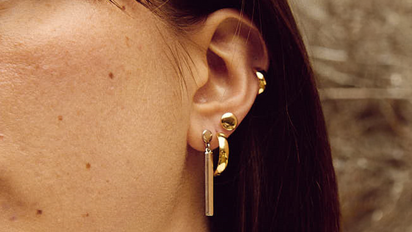 886 stacked gold earrings on a model