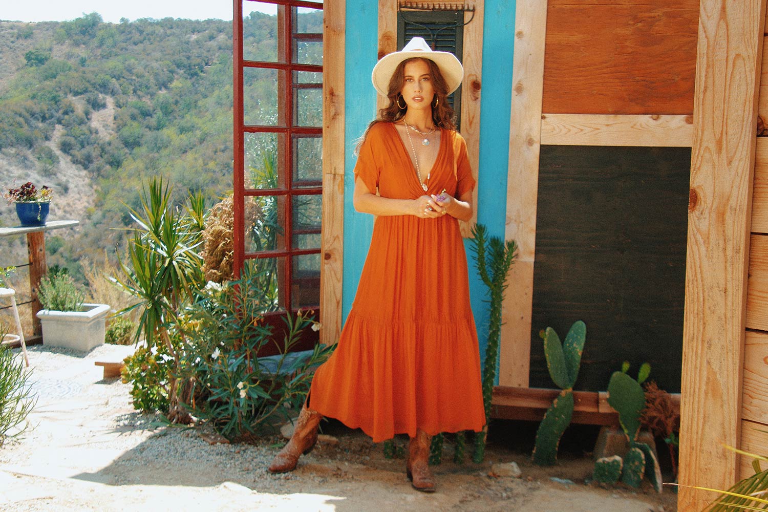 Model in orange maxi dress
