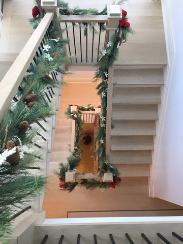 Staircase decorated for Christmas garland