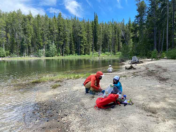 A family camps near an alpine lake.