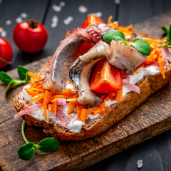 open face sandwich with herring fillet and pickled onions and carrots
