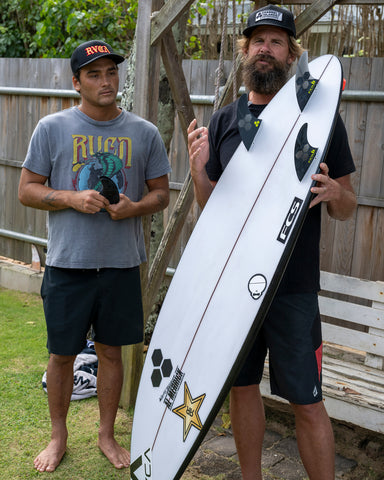 Britt Merrick and Barron Mamiya showing the FCS 2 AM PG Pro fins in a surfboard
