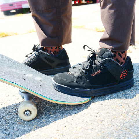 Close up image of a skateboarder wearing a pair of Globe Tilt skate shoes