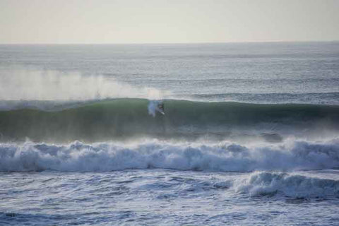 Large wave being surfed at the Pines surf break at Wainui Beach in Gisborne, New Zealand