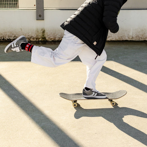 Globe sponsored skateboarder performing a kick push