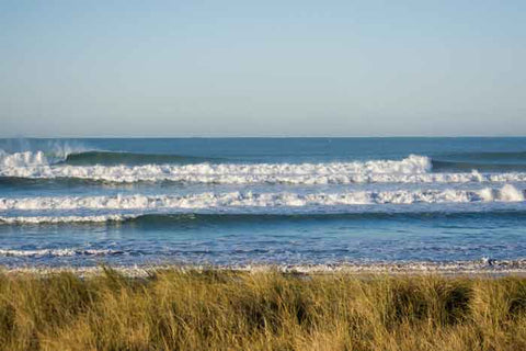 Left hander waves breaking at the Gizzy Pipe surf break at Midway beach in Gisborne